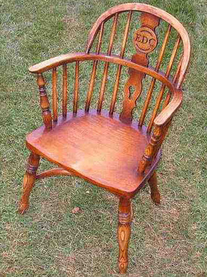 Handmade children's Windsor chair made from local timber, shown outdoors.