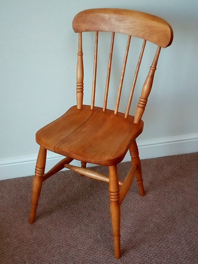 Handmade comb back Windsor chair made from local timber, shown indoors.