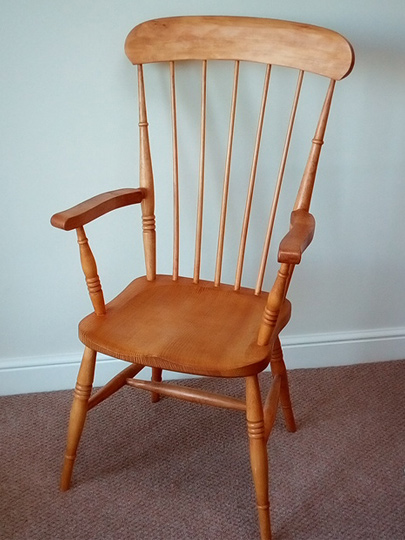 Handmade comb back Windsor chair made from local timber, shown indoors.