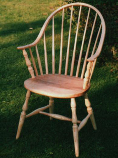 Handmade continuous arm Windsor chair made from local timber, shown outdoors.
