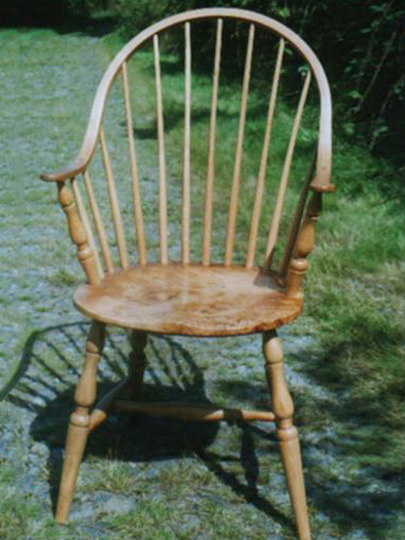 Handmade continuous arm Windsor chair made from local timber, shown outdoors.