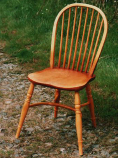 Handmade back hoop Windsor chair made from local timber, shown outdoors.