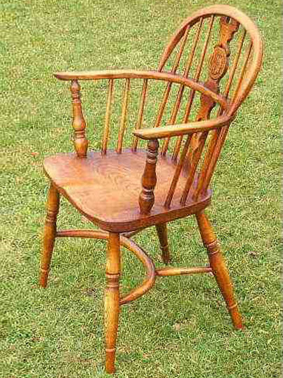 Handmade low back carver Windsor chair made from local timber, shown outdoors.