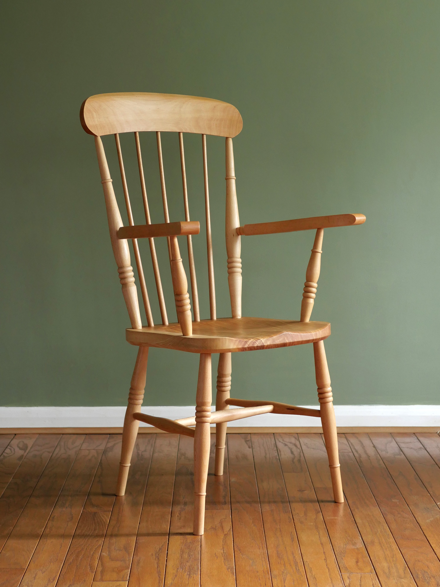 Handmade comb back Windsor armchair made from local timber, shown indoors.