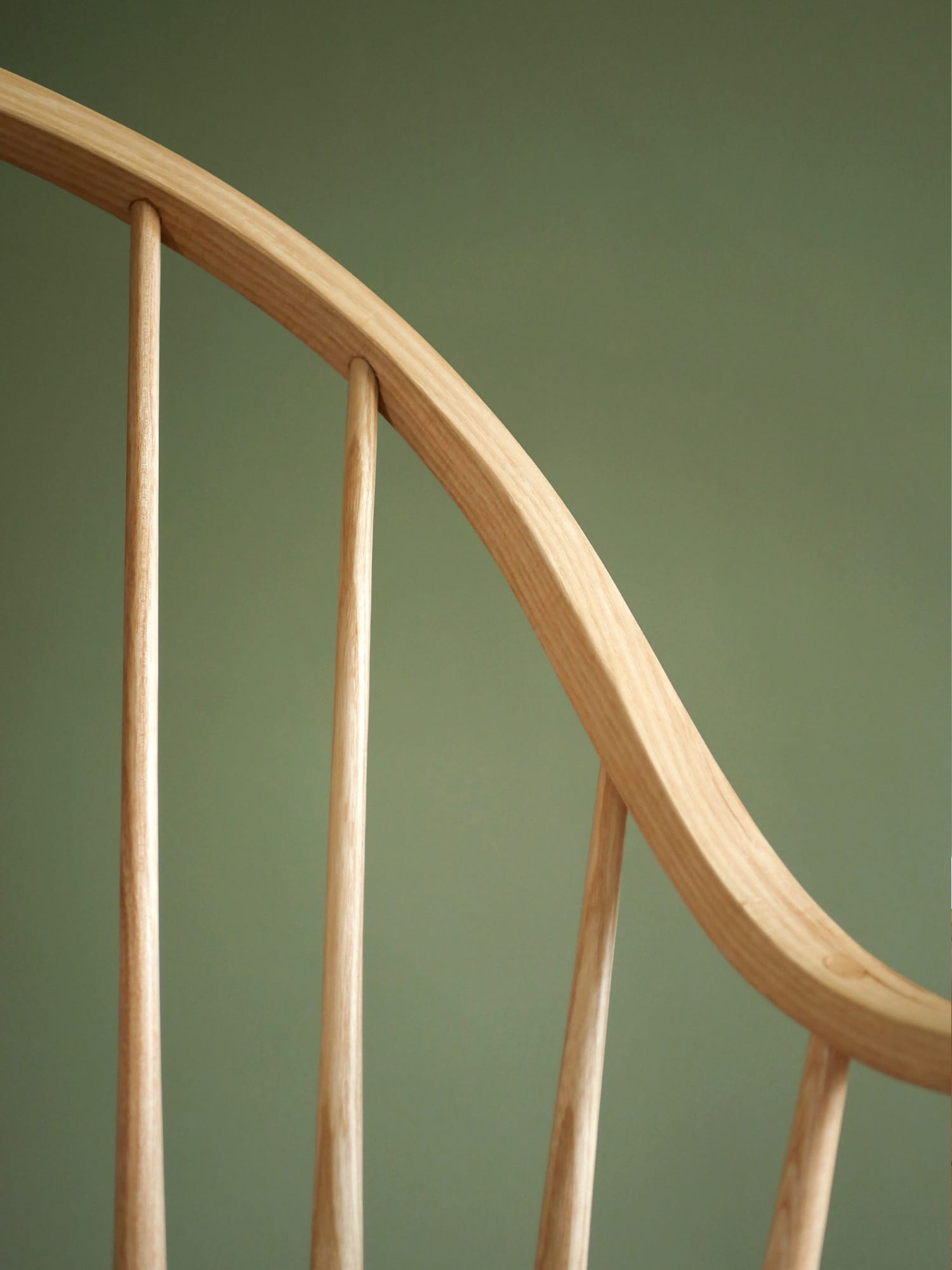 Handmade American style continuous arm Windsor chair in ash.