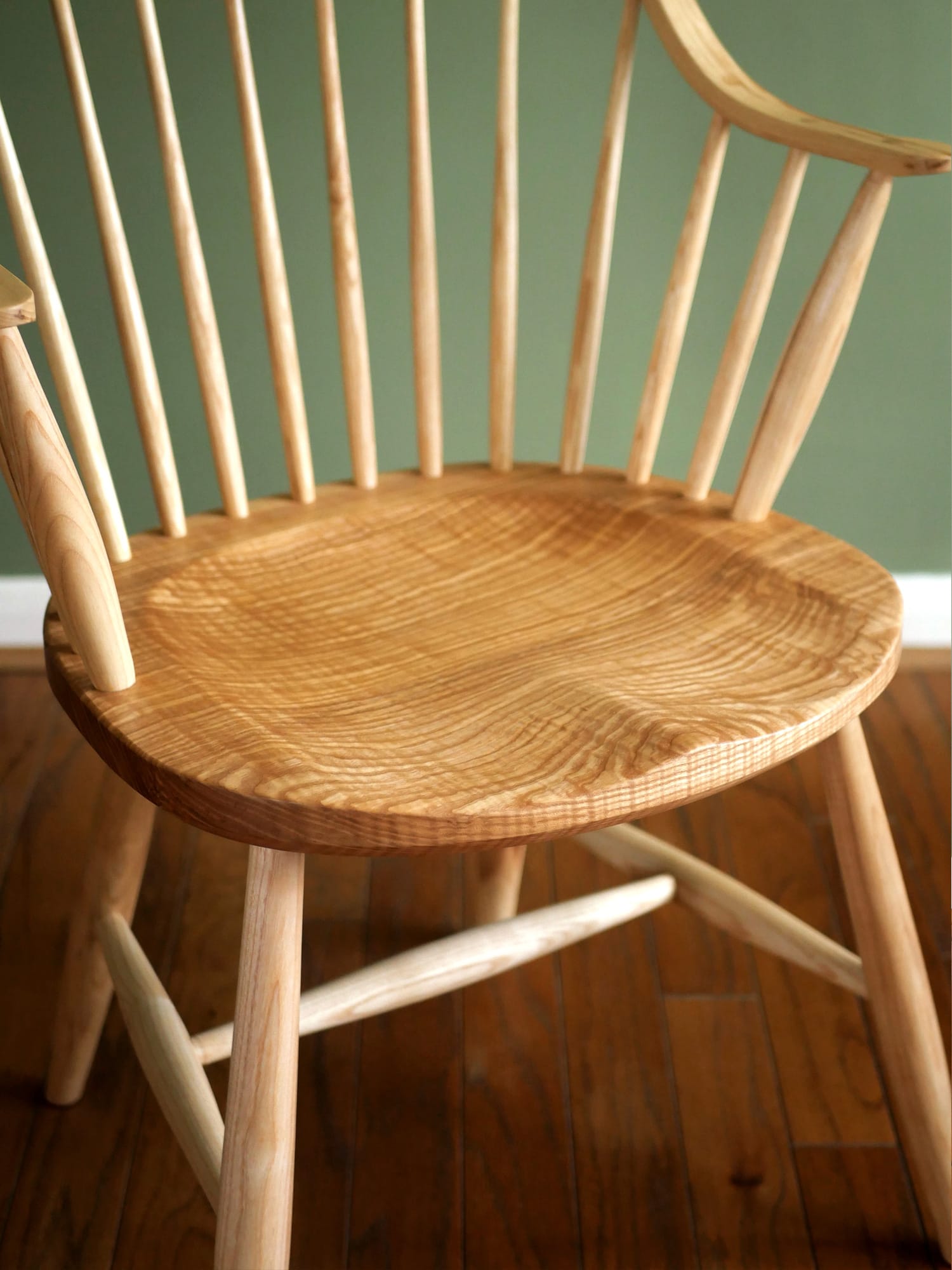 Handmade American style continuous arm Windsor chair in ash.