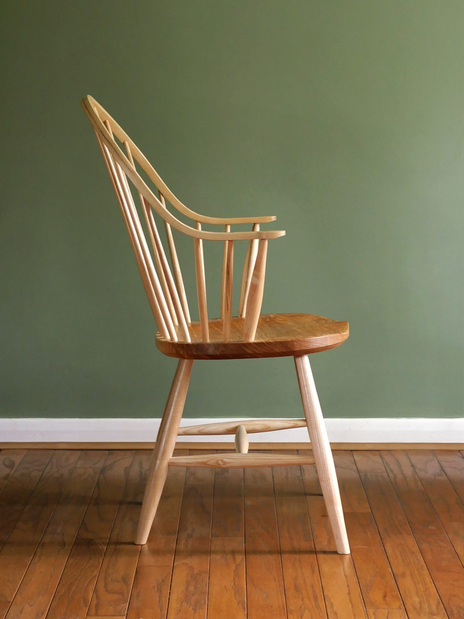 Handmade American style continuous arm Windsor chair in ash.